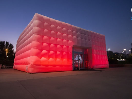 Red illuminated Optix inflatable cube used as a custom exhibition stand