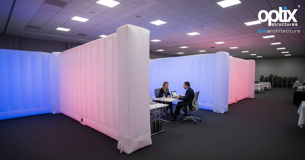 Optix inflatable walls dividing an indoor conference hall into separate operational areas.