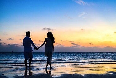 man-and-woman-holding-hands-walking-on-s