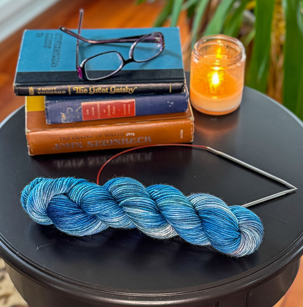 Thumbnail: Blue variegated yarn with books and a candle