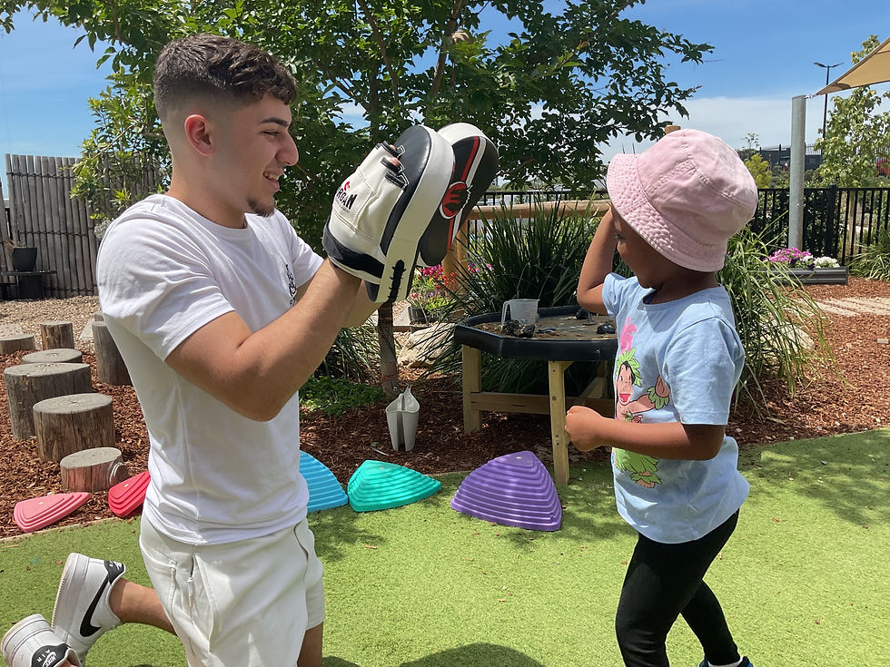 Kids punching pads for heavy work at childcare centre.