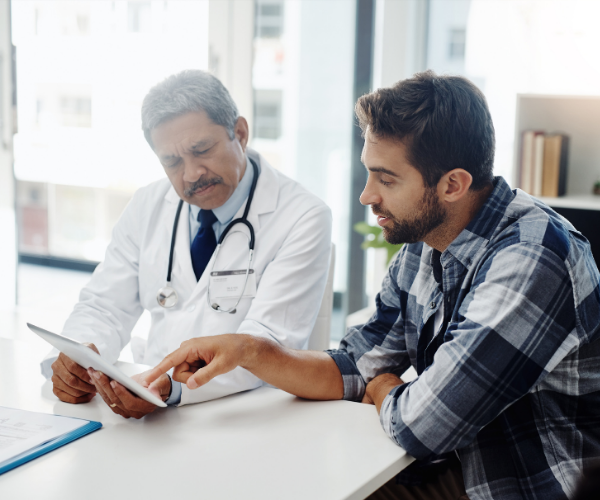 Man speaking with his doctor about LBP red flags
