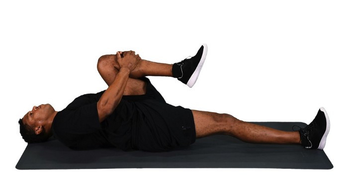 Doing a knee-to-chest stretch can help elongate the lower back and can relieve pain and reduce tension.