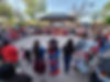 A large group of individuals standing in a circle, celebrating Indigenous people in O’ga P’ogeh, Santa Fe, NM