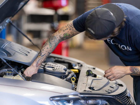 Engine Bay Inspection at Precision Auto Repair Technician with Dark Blue Shirt that Precision