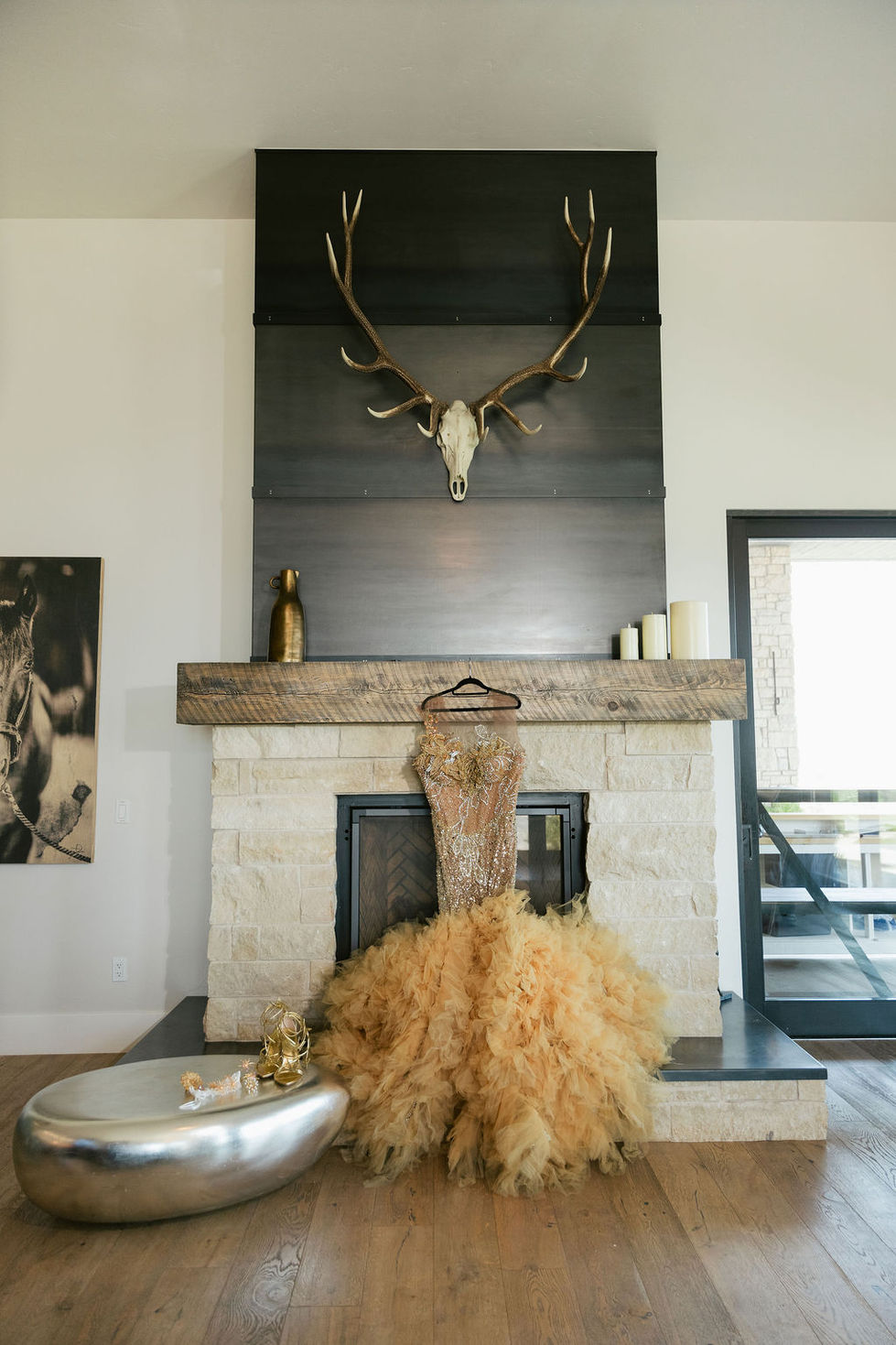 a gold dress is hanging on a fireplace mantle