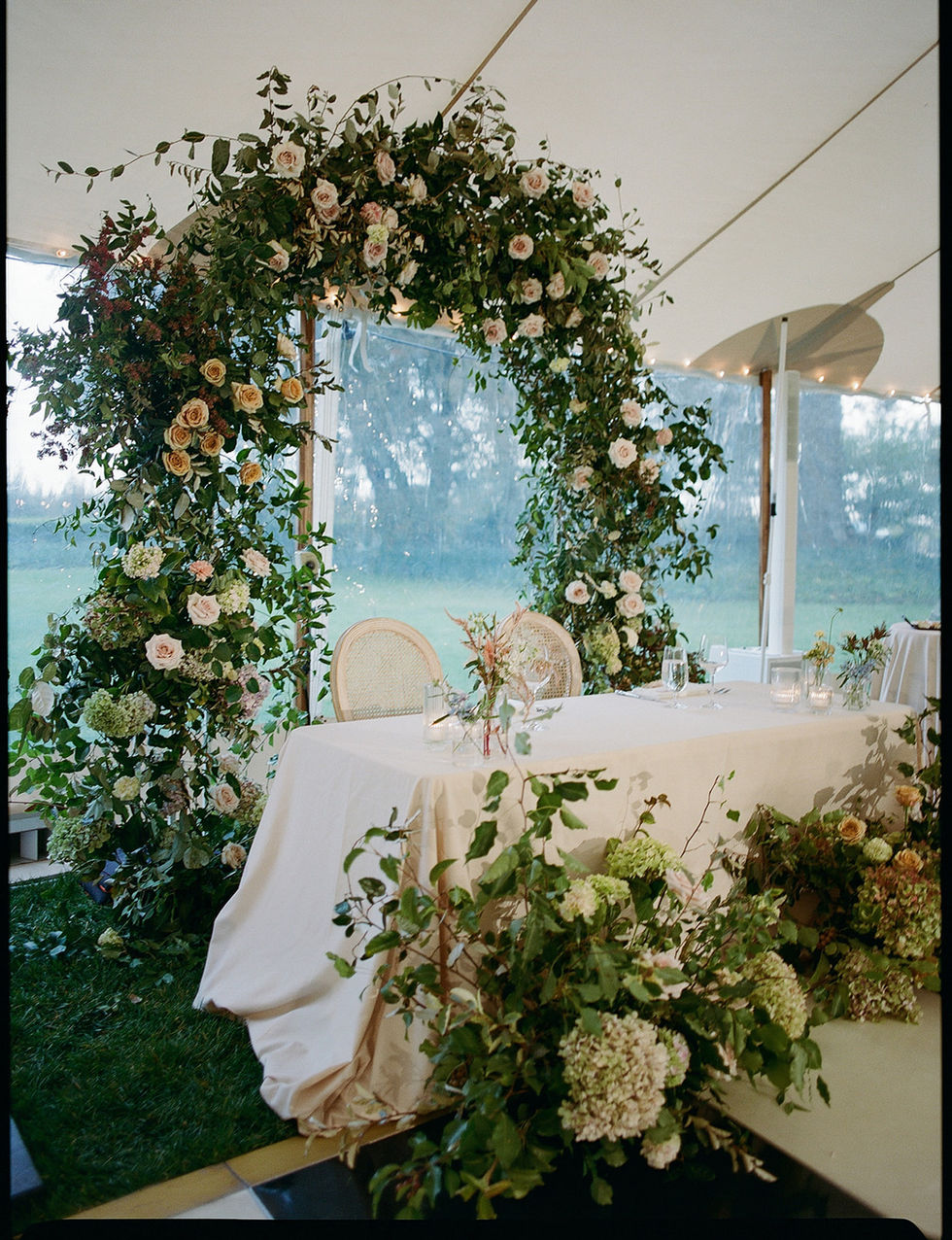 a table in a tent with flowers on it
