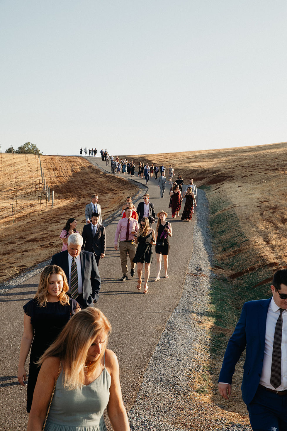 a group of people are walking down a road