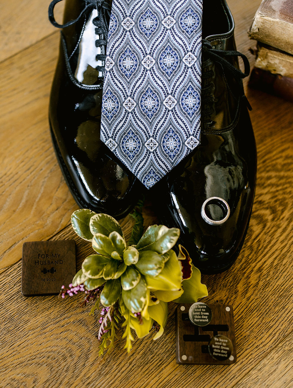 a pair of black shoes with a tie and a card that says for my husband