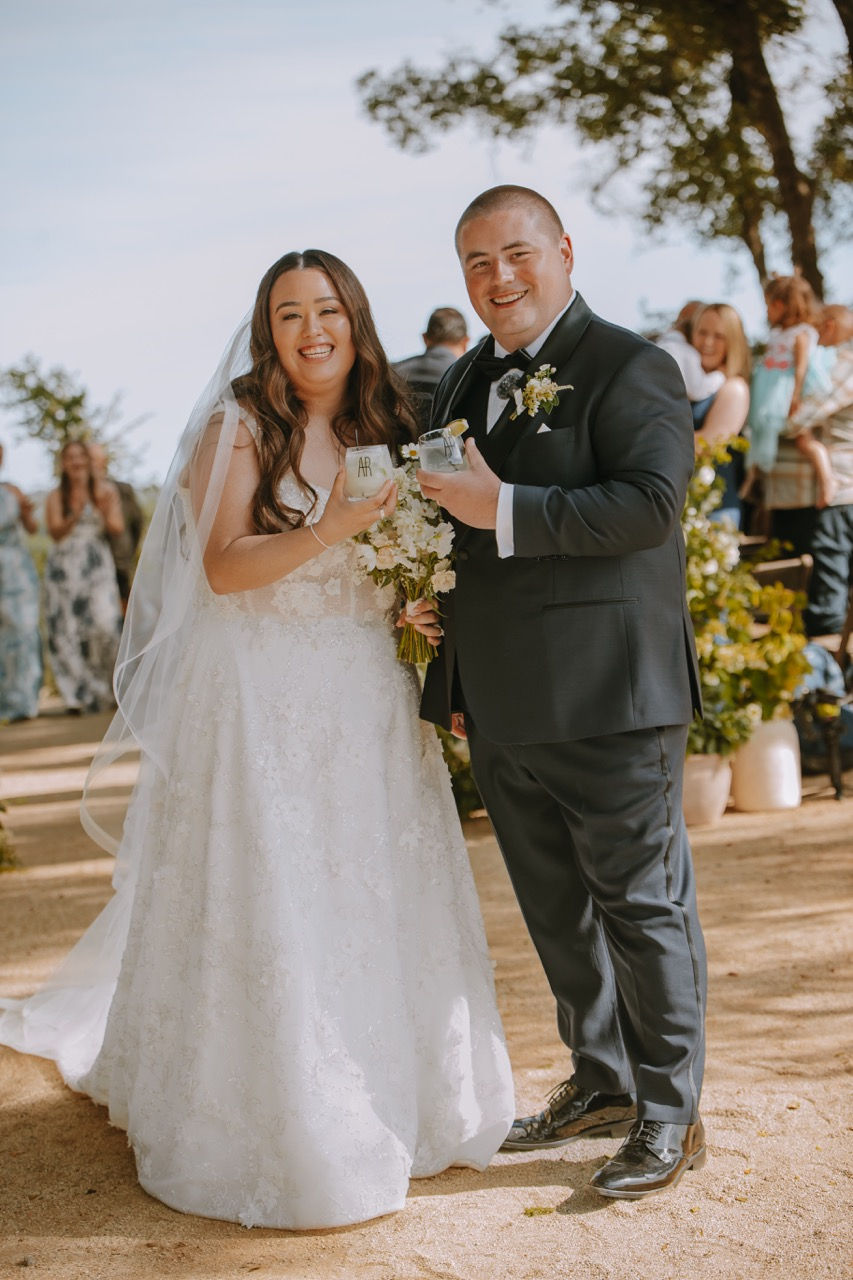 a bride and groom are posing for a picture and the bride is wearing a white dress