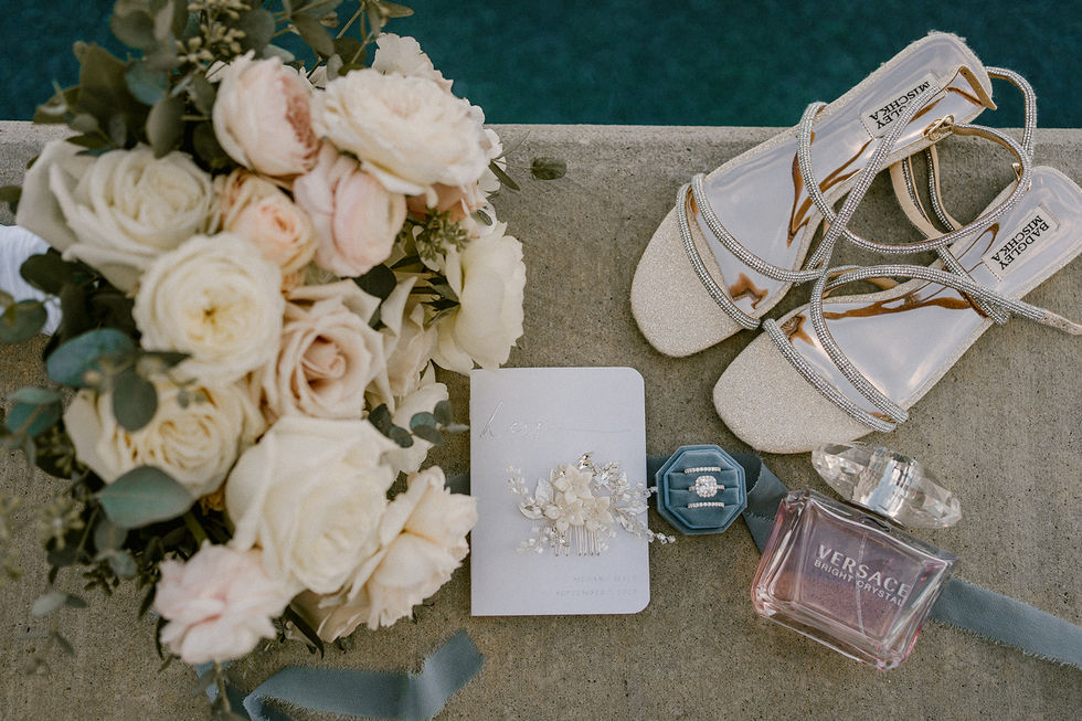 a bottle of vera wang perfume sits next to a bouquet of flowers