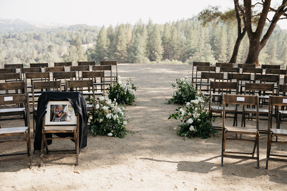 a row of wooden chairs with flowers and a sign that says thank you for being a friend