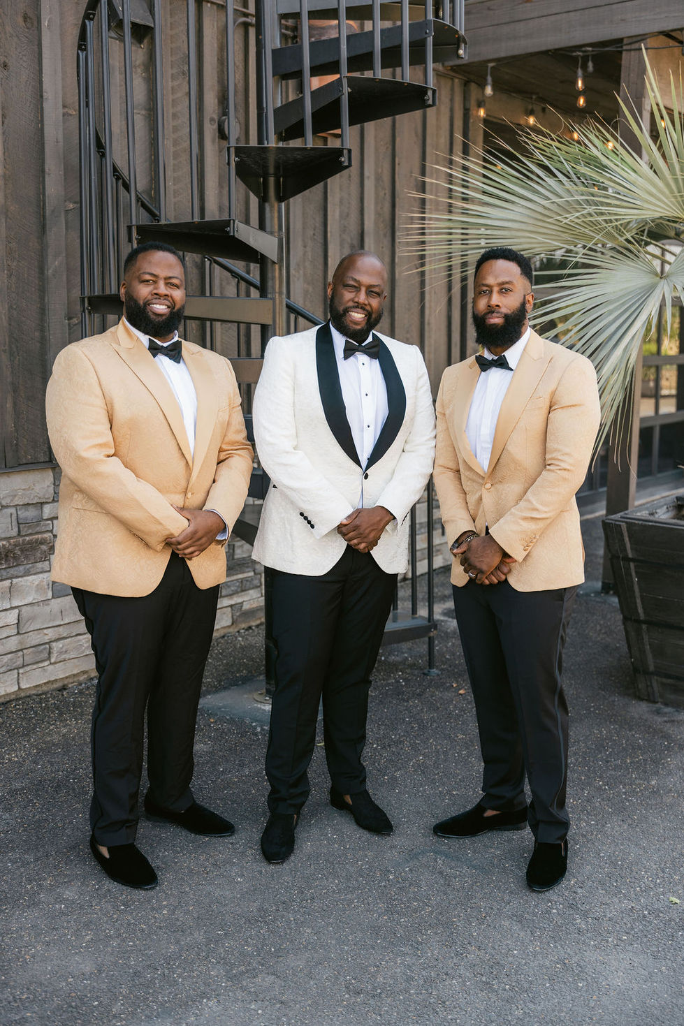 three men in tuxedos and bow ties stand next to each other