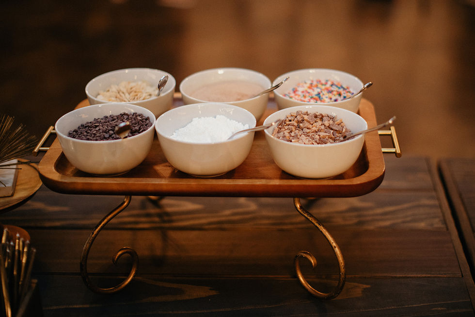 a wooden tray with bowls of different toppings on it