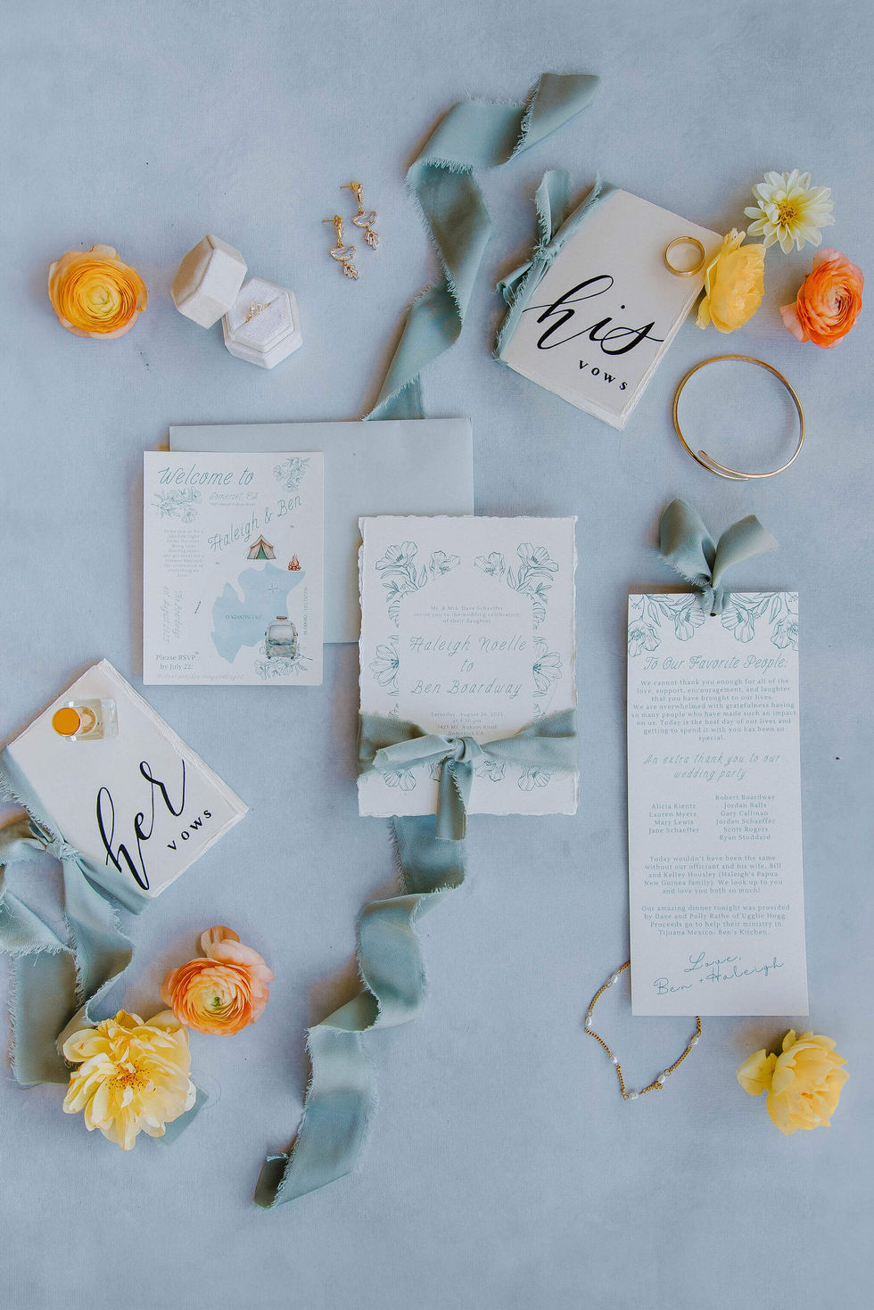 a wedding invitation for raleigh and bill sits on a table