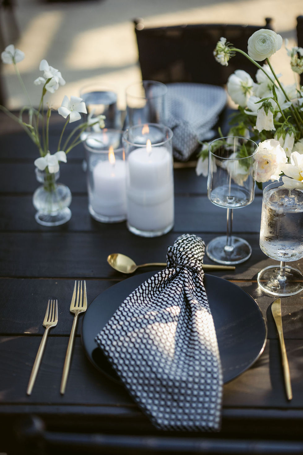 a black plate with a black and white napkin on it