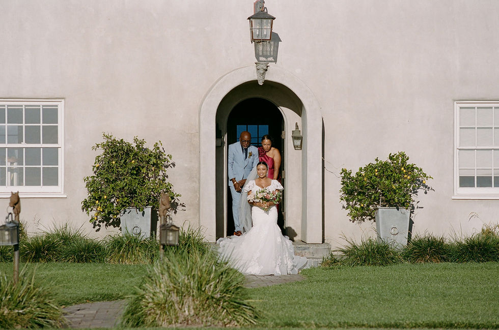 a bride is walking down the aisle with her parents