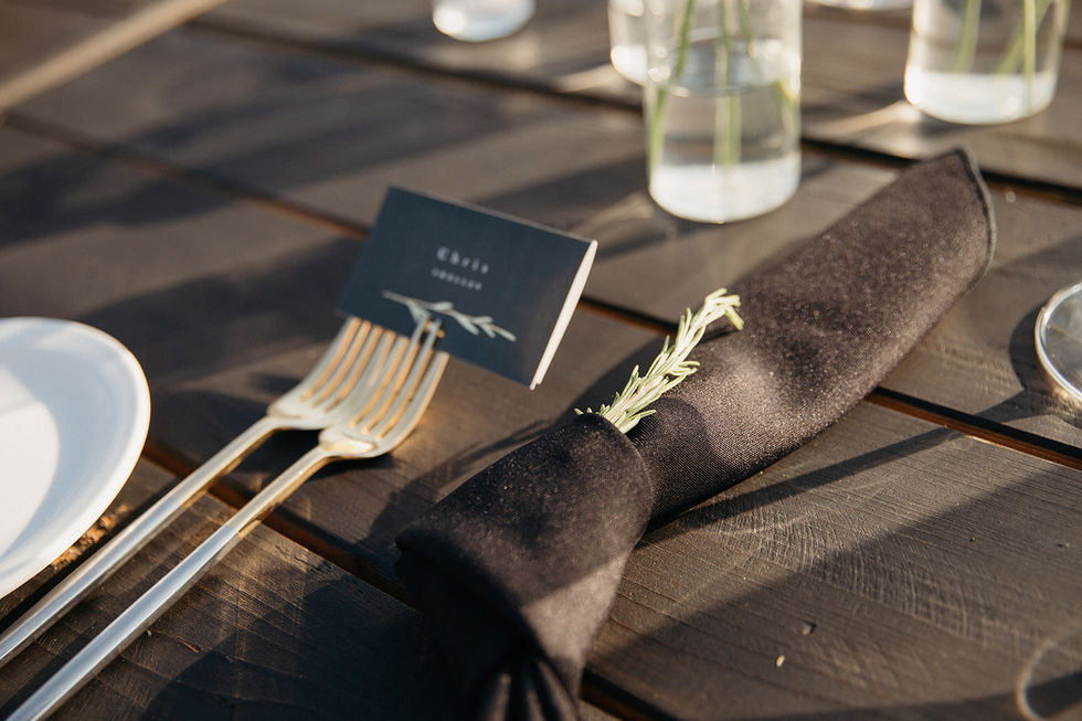a place card for chris sits on a napkin on a table