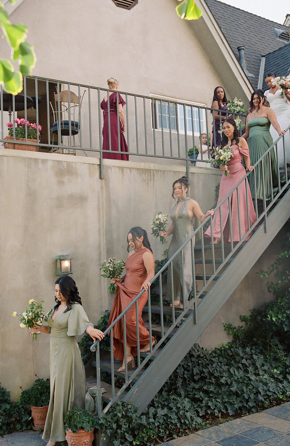 a group of women are walking down a set of stairs