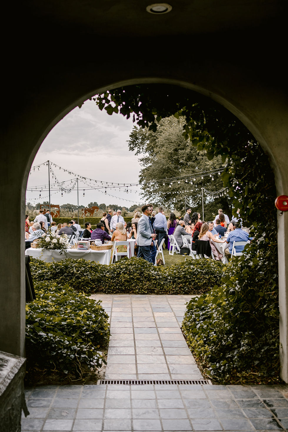 a group of people are gathered outside at a wedding reception