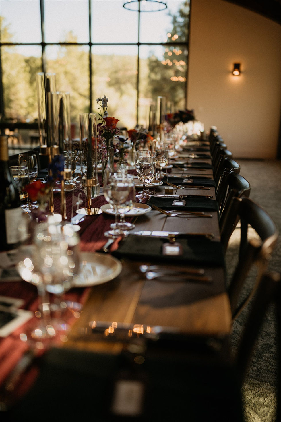a long table is set with plates glasses and silverware