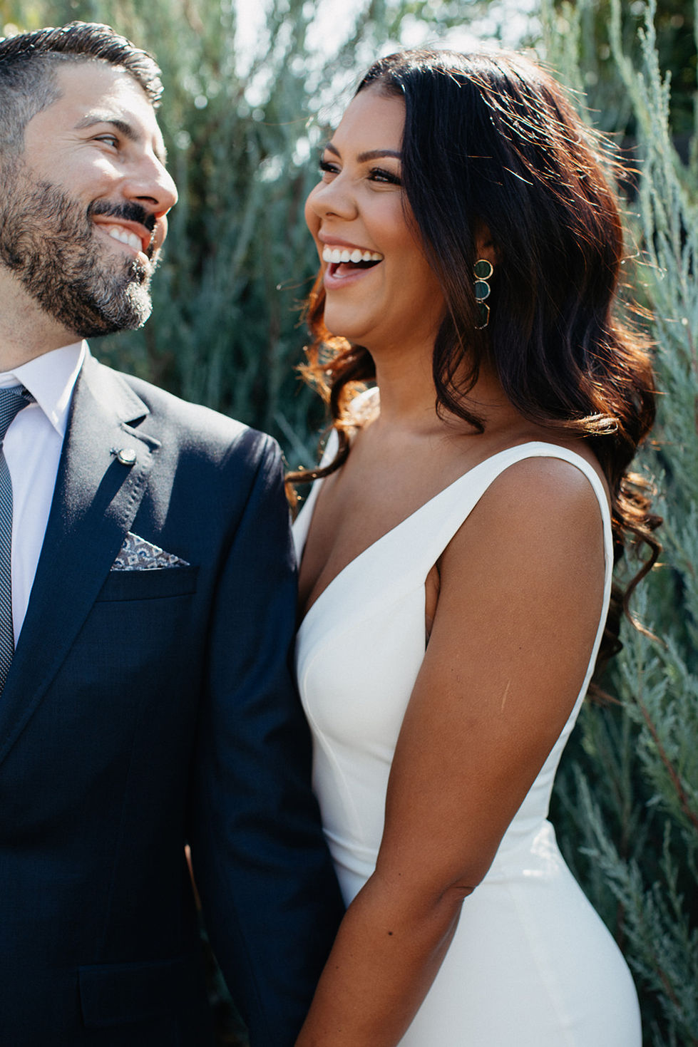 a man in a suit and tie is smiling next to a woman in a white dress