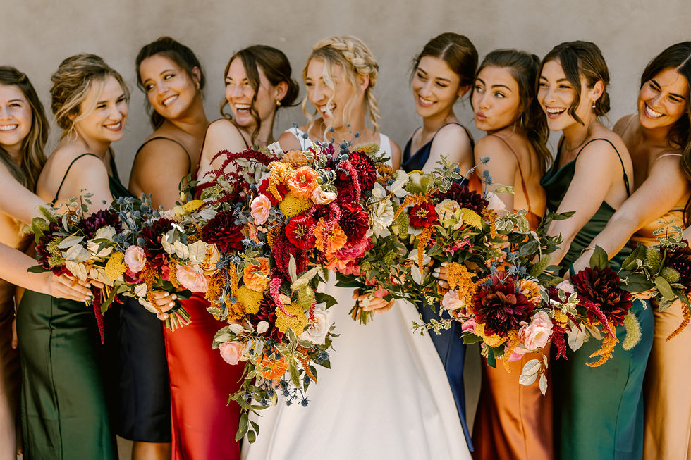 a bride and her bridesmaids are posing with their bouquets of flowers