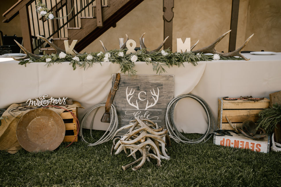 a table with antlers and a sign that says love