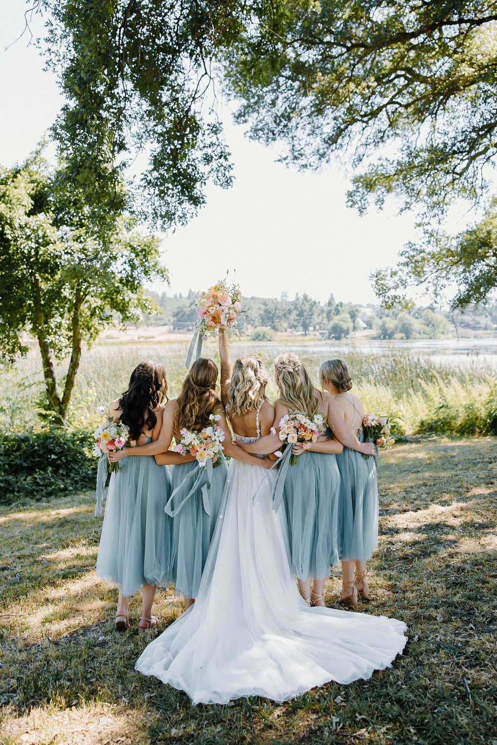 the bride and her bridesmaids are posing for a picture