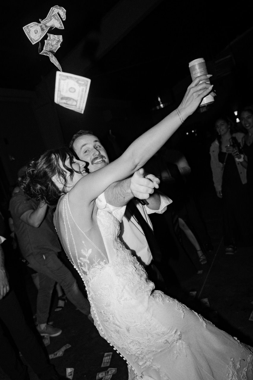 a black and white photo of a bride and groom dancing