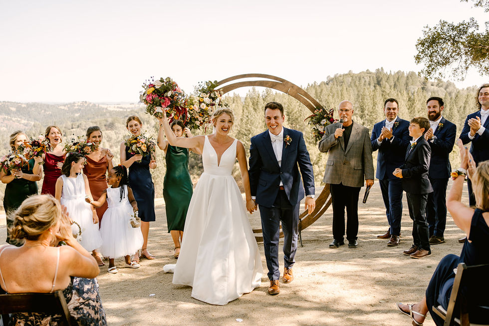 a bride and groom are walking down the aisle at their wedding