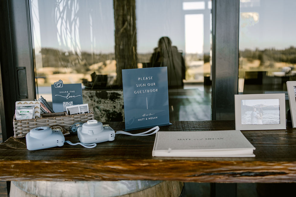 a table with a sign that says please sign our guestbook