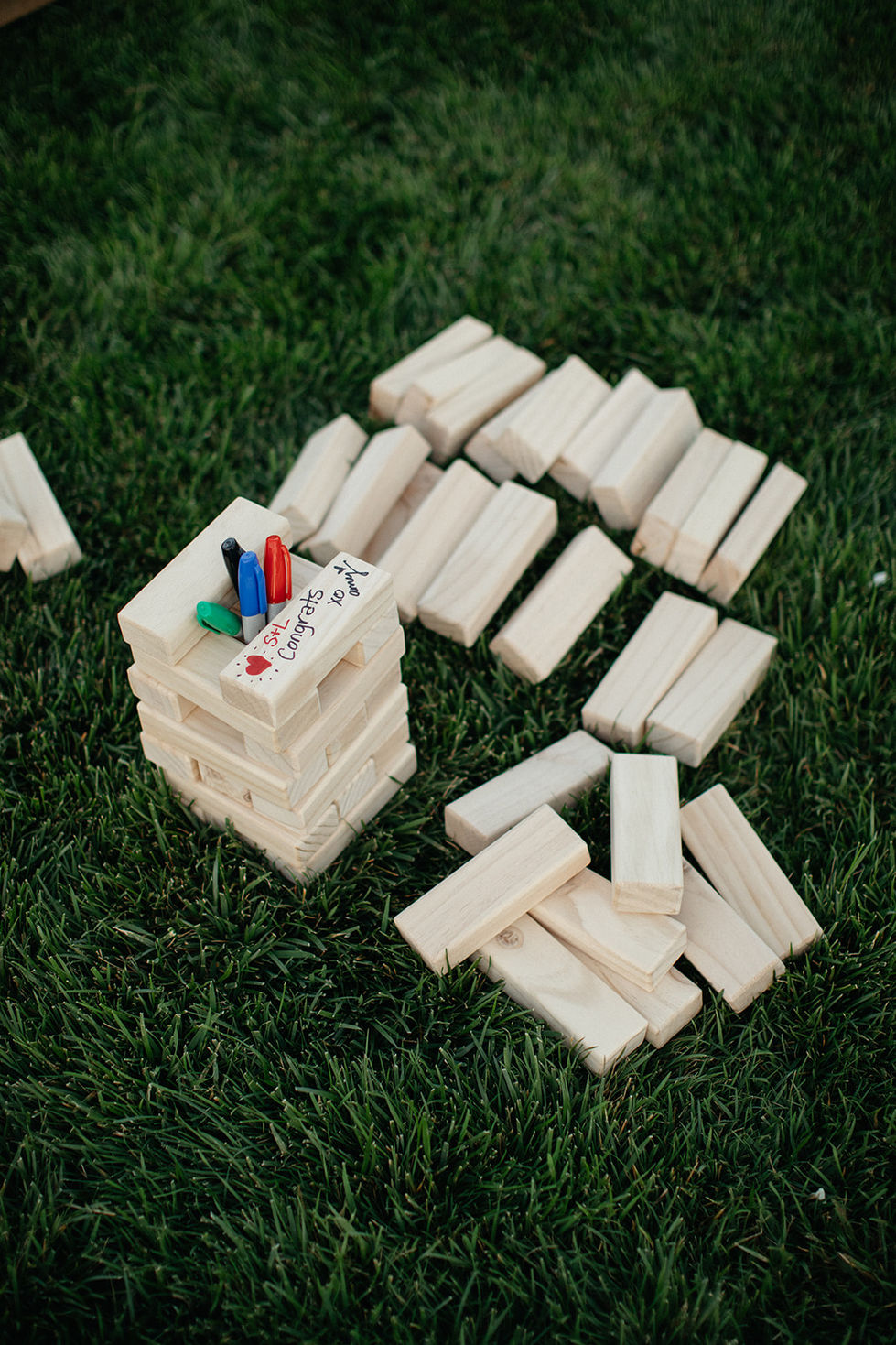 a stack of wooden blocks with a marker that says " congratulations " on it