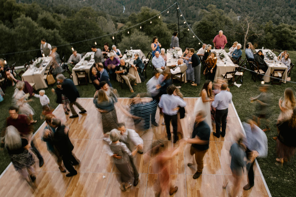 a group of people are dancing on a wooden dance floor