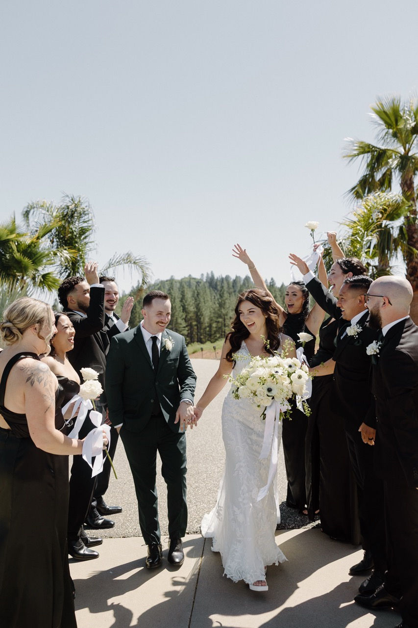 a bride and groom are surrounded by their wedding party