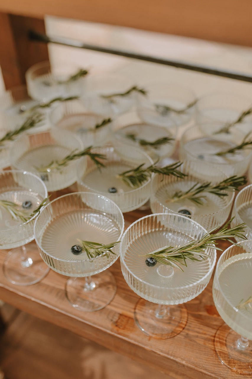 Welcome drink lemonade vodka with a blueberry and rosemary garnish