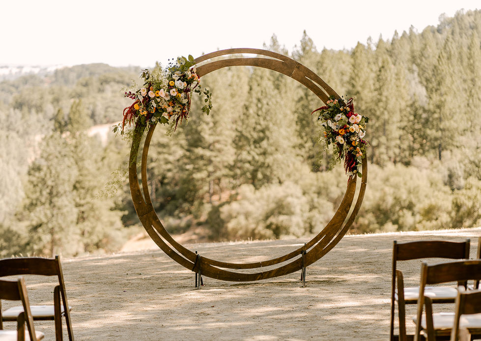 a wooden circle decorated with flowers and leaves