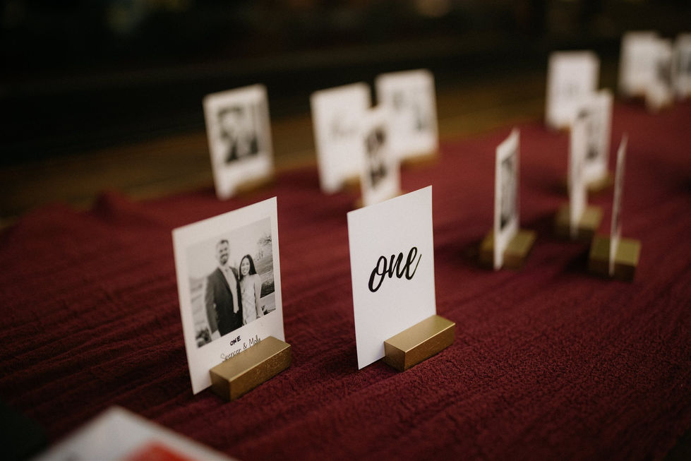 a table with several place cards one of which has a picture of a bride and groom on it