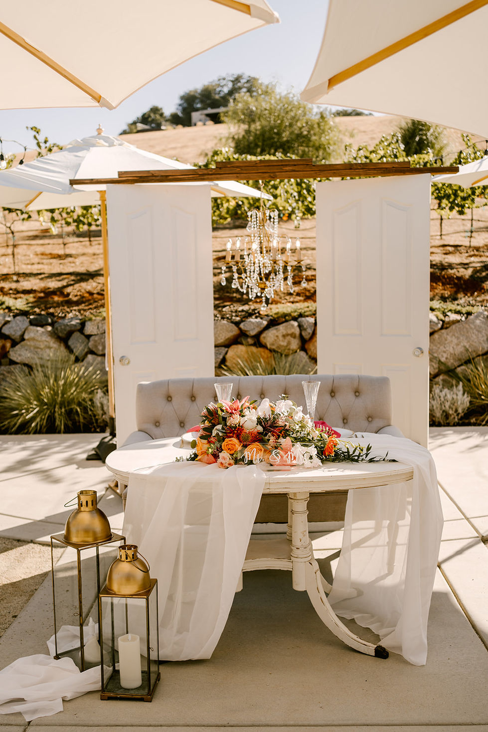 a table with a chandelier and flowers on it
