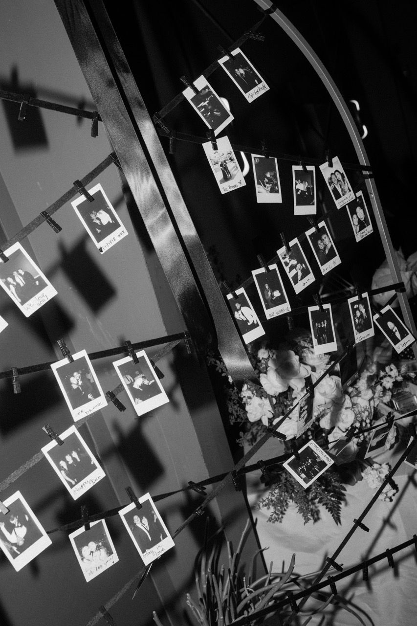 a bunch of pictures hanging on a string with one that says ' the bride ' on it