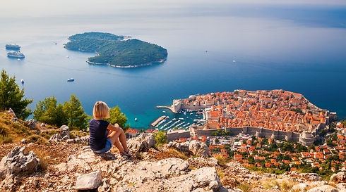 woman sitting looking out into the ocean and croatia