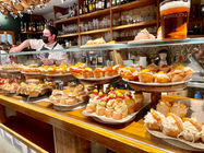 A Pintos bar with a dozen trays of bite sized food on display