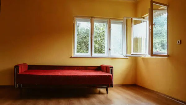 Japandi living room interior with warm greige walls, minimalist wooden furniture, and neutral textiles for nervous system regulation and home color psychology 2026.