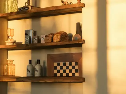 Warm wooden kitchen shelves with natural objects and golden light