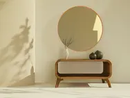 Minimalist wooden console table with round mirror and decorative vases in warm neutral bedroom