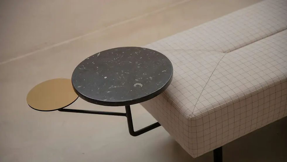 Black marble and brass side table beside upholstered bench best furniture stores in the US for designer-look home decor