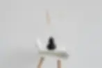 Japandi wabi-sabi vignette with live edge wood side table unglazed ceramic vase dried botanicals and minimalist line art on warm white wall