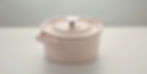Pale pink enameled cast iron dutch oven on a white surface Le Creuset style PFAS-free cookware tested and reviewed for longevity in 2026