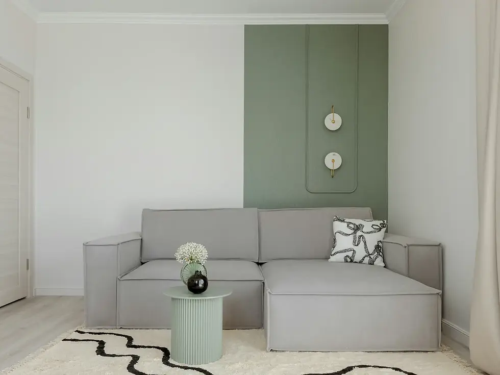 Warm minimalist living room with an oatmeal low-pile area rug under a linen sofa