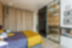 Linen curtain divider on ceiling track separating sleeping zone from living area in studio apartment  renter-friendly room divider idea